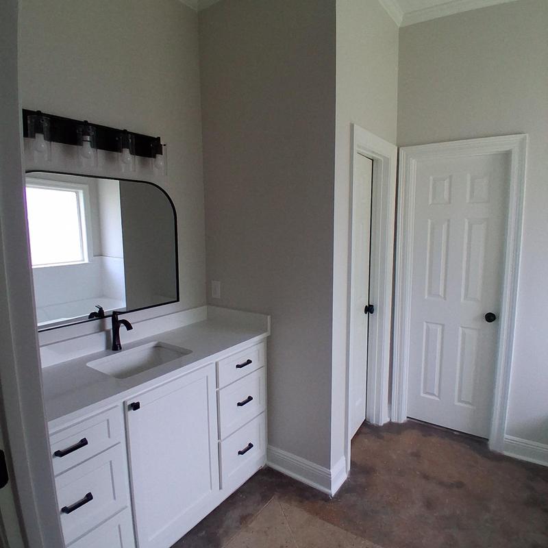 Bathroom vanity with sink and black fixtures in remodel