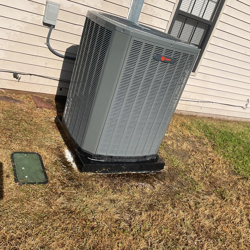Condenser unit cleaning and inspection on outdoor HVAC system