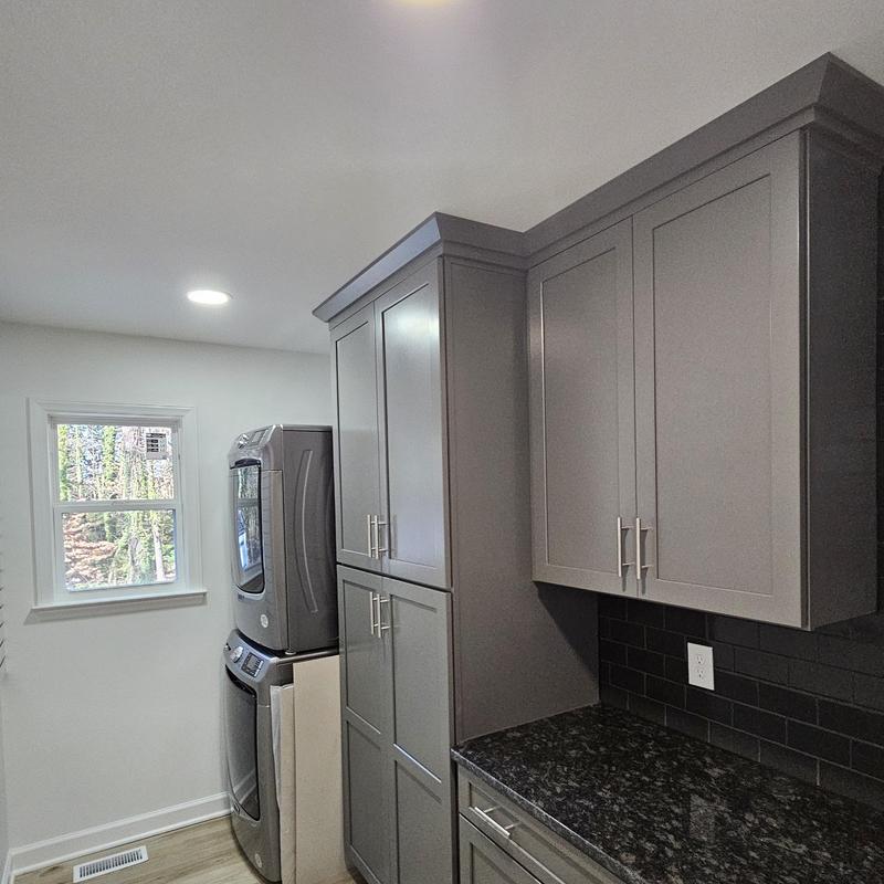 Laundry room gray cabinets and granite countertop installation