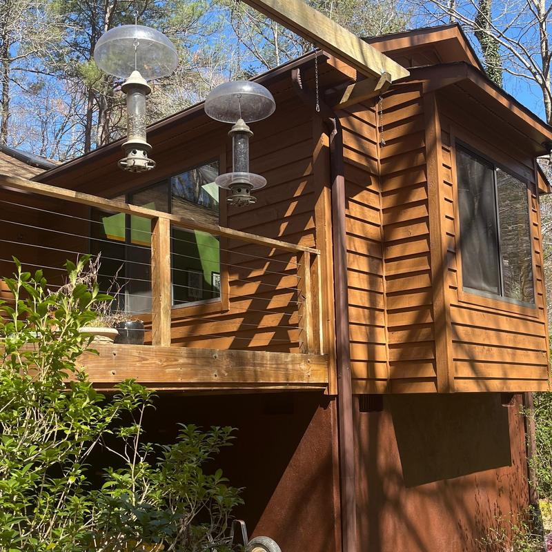 Wood siding and railing on raised deck exterior Wood siding and railing on raised deck exterior