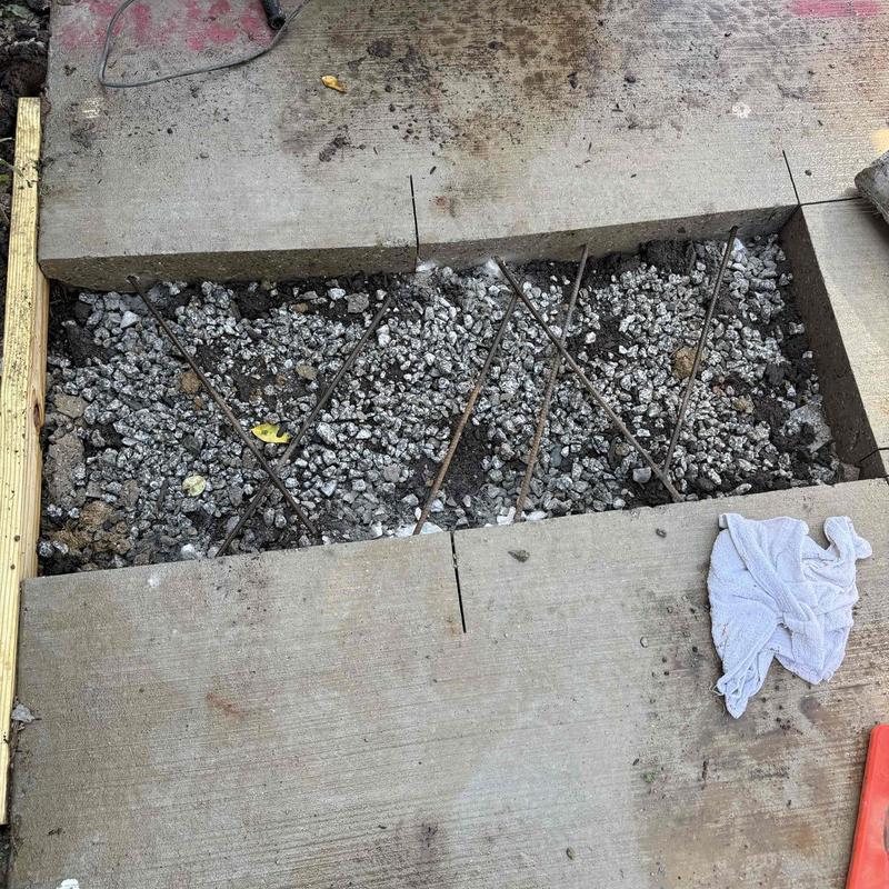 Concrete sidewalk section with rebar and gravel fill