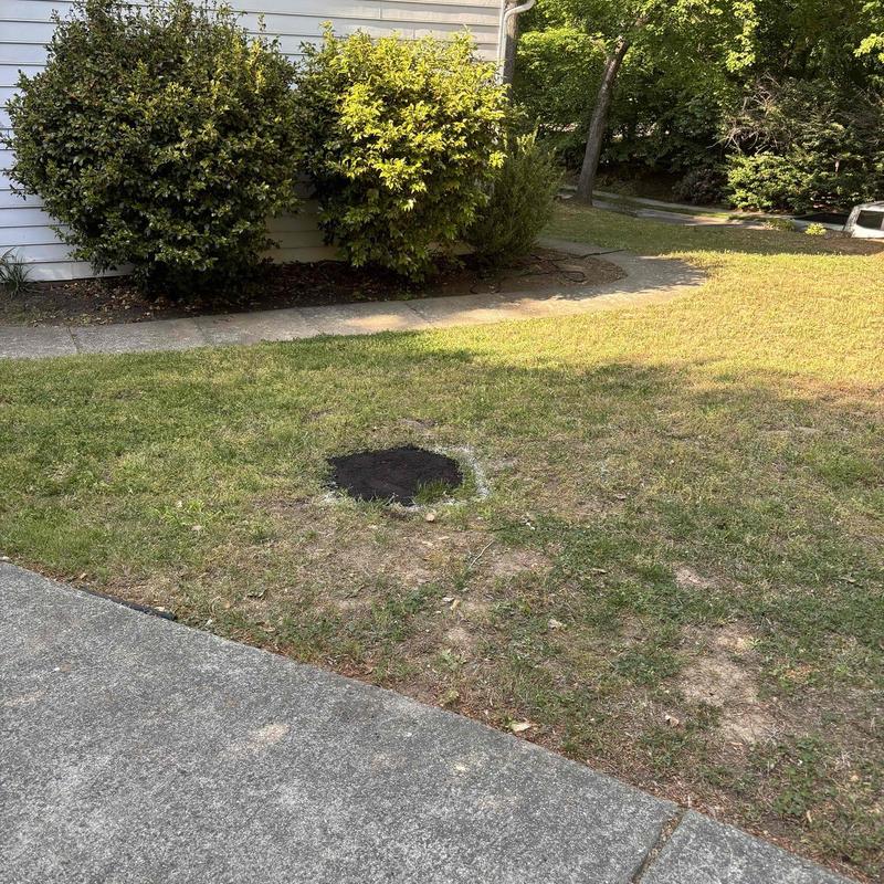 Underground pipe repair site with soil patch