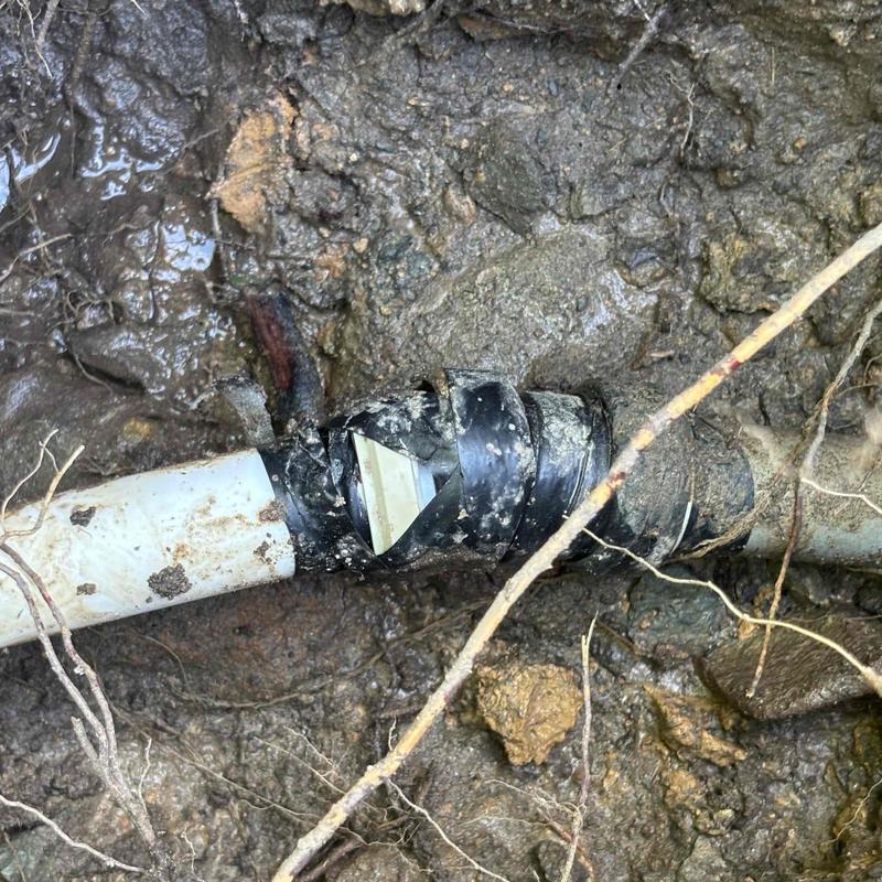 Underground PVC pipe joint with sealing tape repair