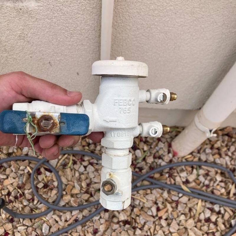 Pressure vacuum breaker valve with blue handle outdoors
