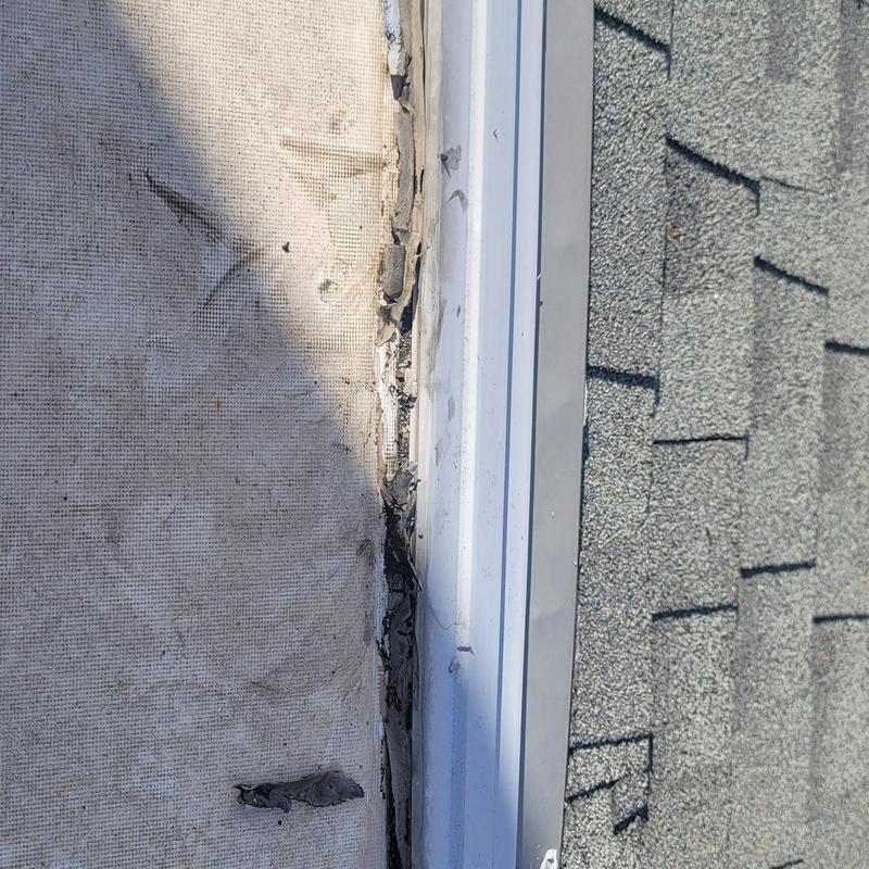 Roof flashing with hail damage on shingles edge