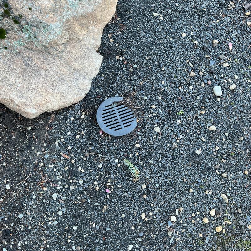 Drain cleanout with gravel and rock surrounding