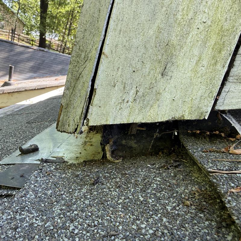 Chimney flashing and damaged soffit on roof