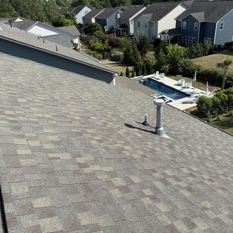 Asphalt shingle roof with vent pipes and pool view