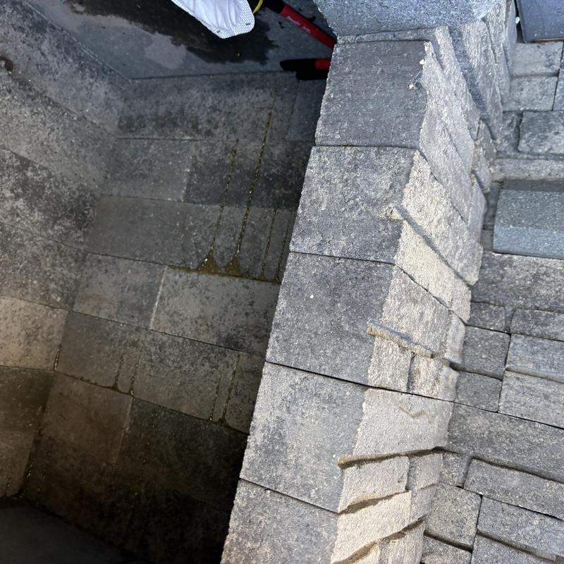 Fireplace insert masonry enclosure under inspection