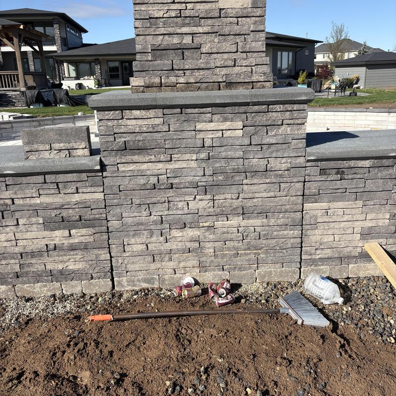 Stone fireplace exterior wall with construction debris