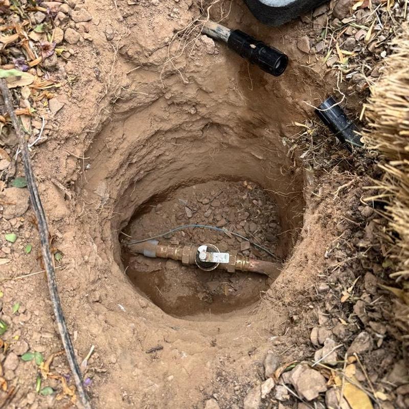 Water main valve installation in dug hole