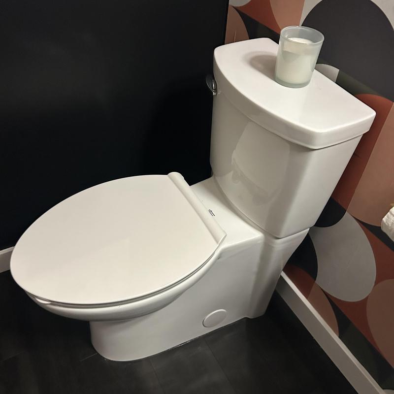 Toilet fixture installation in modern bathroom corner