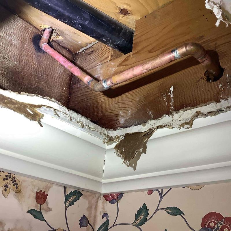 Copper water pipe in ceiling cavity with drywall damage