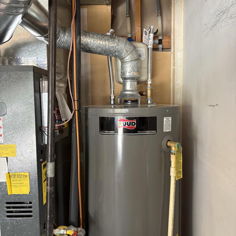 Water heater with vent pipe and plumbing connections