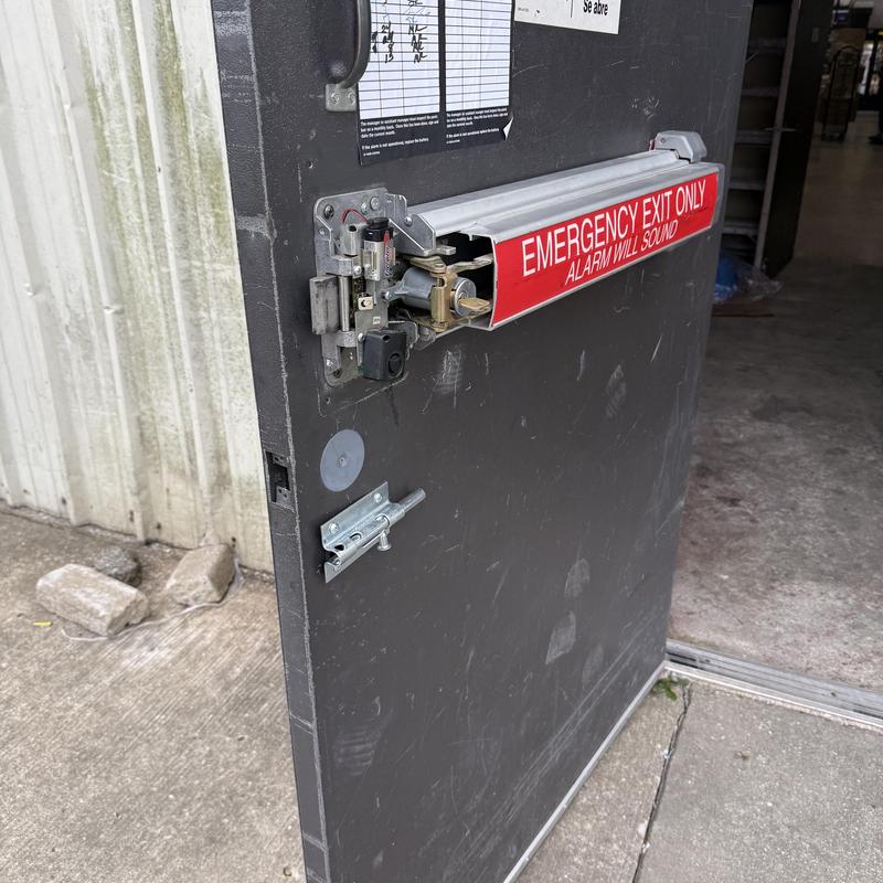 Exit device on emergency exit door with key cylinder
