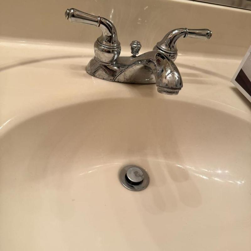 Kohler centerset bathroom faucet and drain in sink