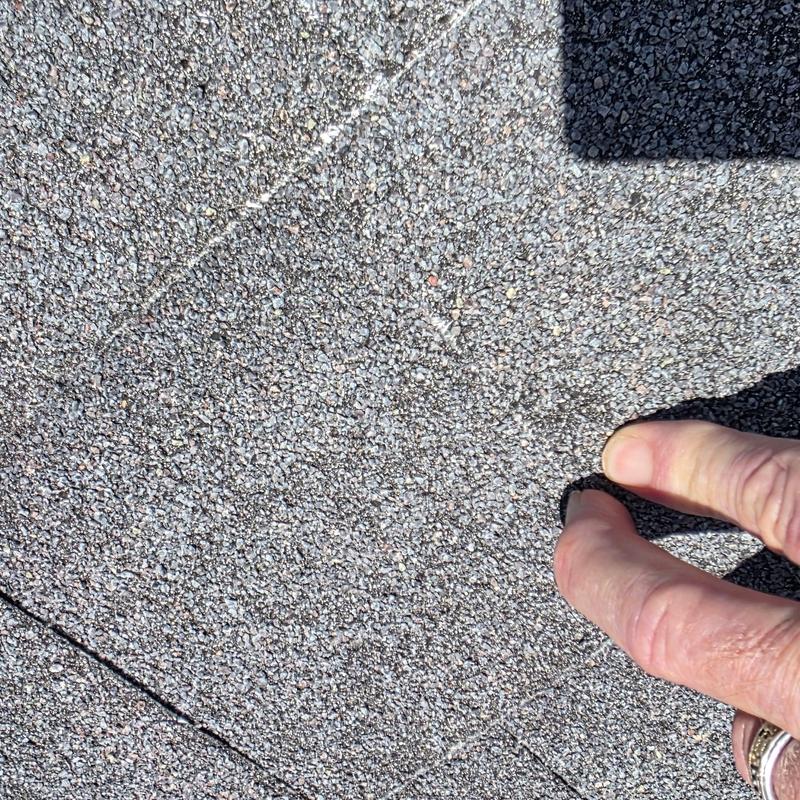 Asphalt shingle roof showing hail damage close-up