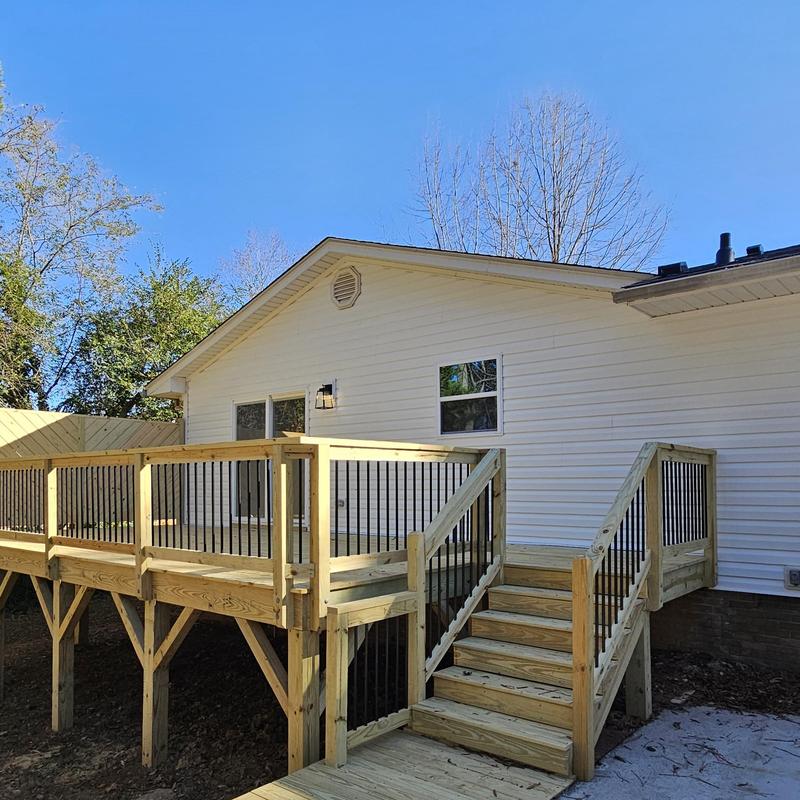 Wooden deck with metal railings and stairs installation