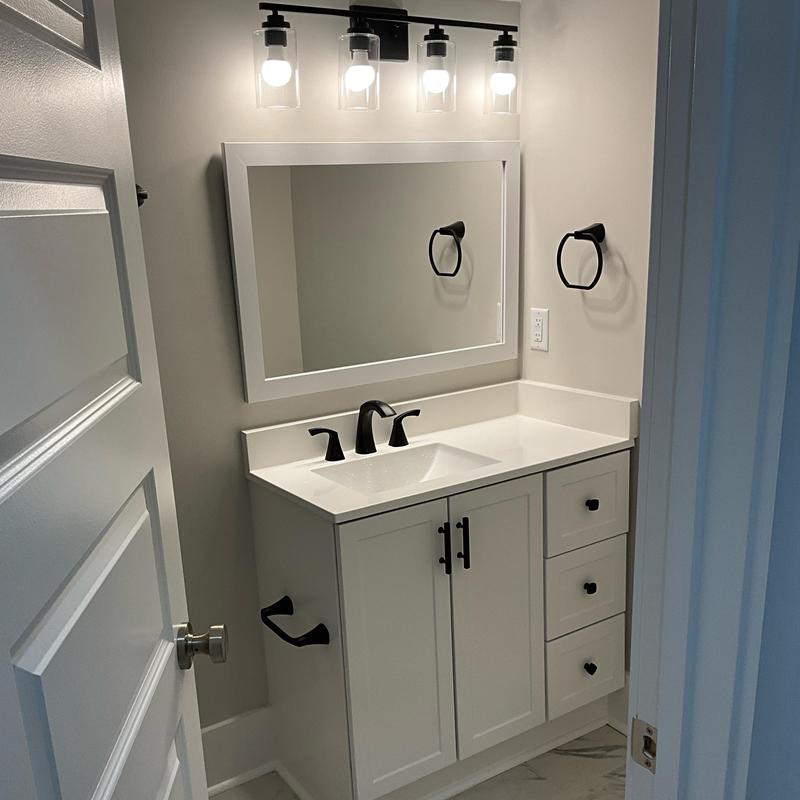Bathroom vanity with faucet and black hardware