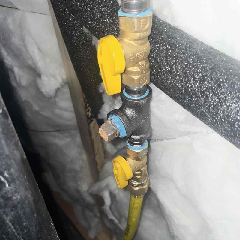 Gas line with yellow shutoff valves and insulation