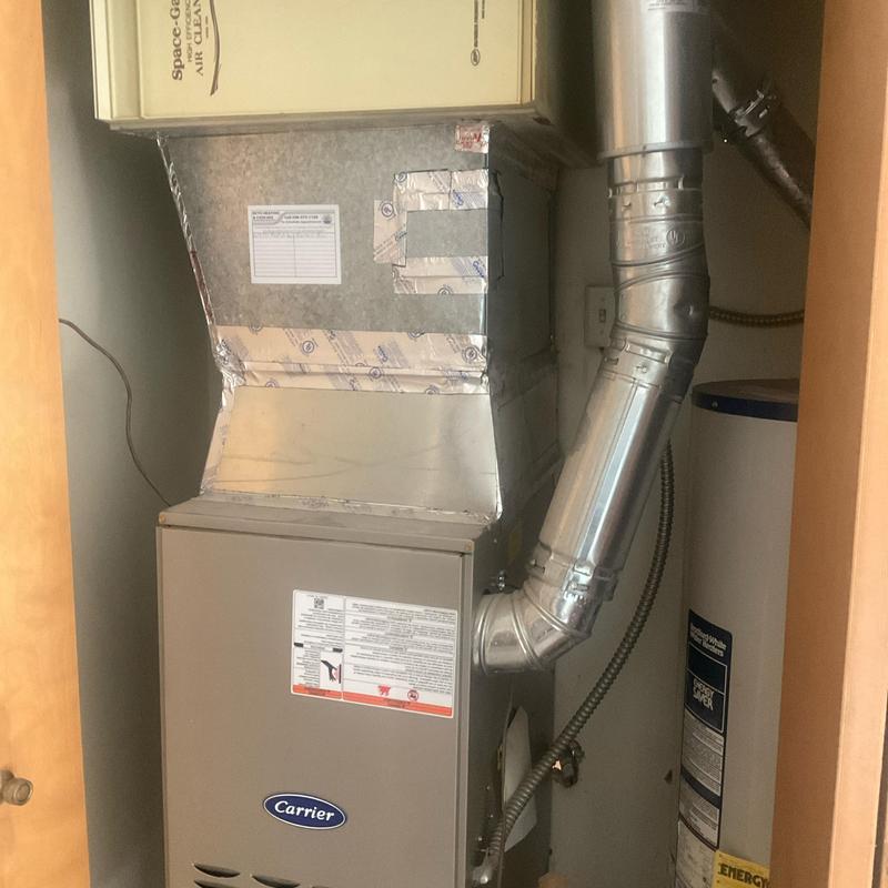HVAC furnace unit with ductwork in utility closet