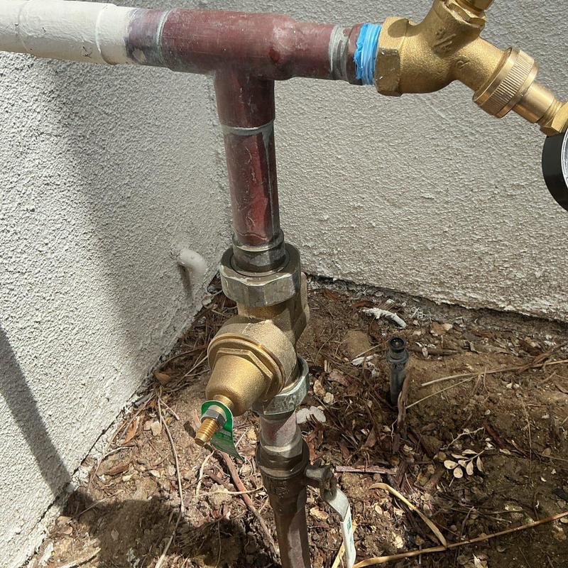 Pressure regulator and hose bib outdoor plumbing system
