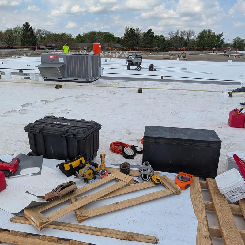 TPO single ply roofing membrane installation tools on roof