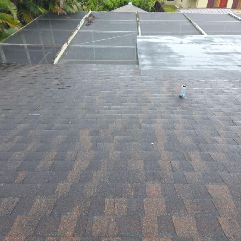 Asphalt shingle roof with adjacent screened patio flat roof
