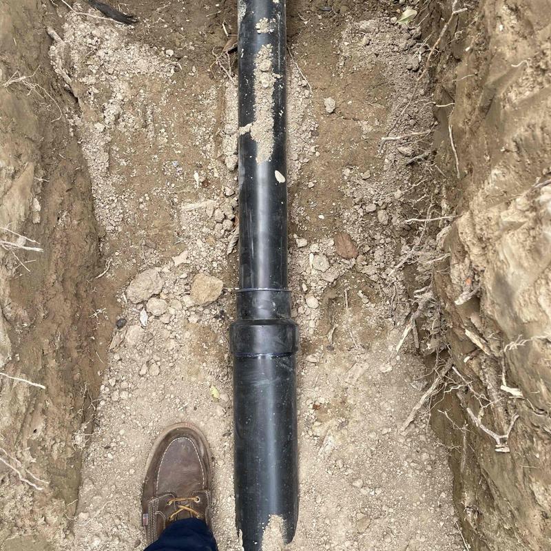 Main sewer line PVC pipe installation in trench