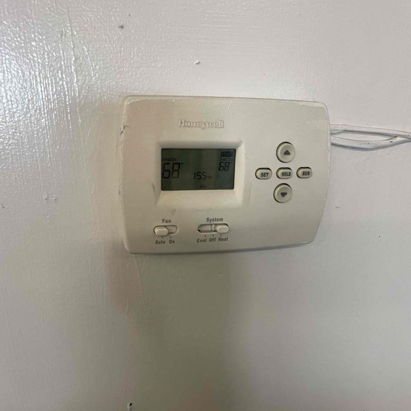 Programmable Honeywell thermostat on wall for furnace