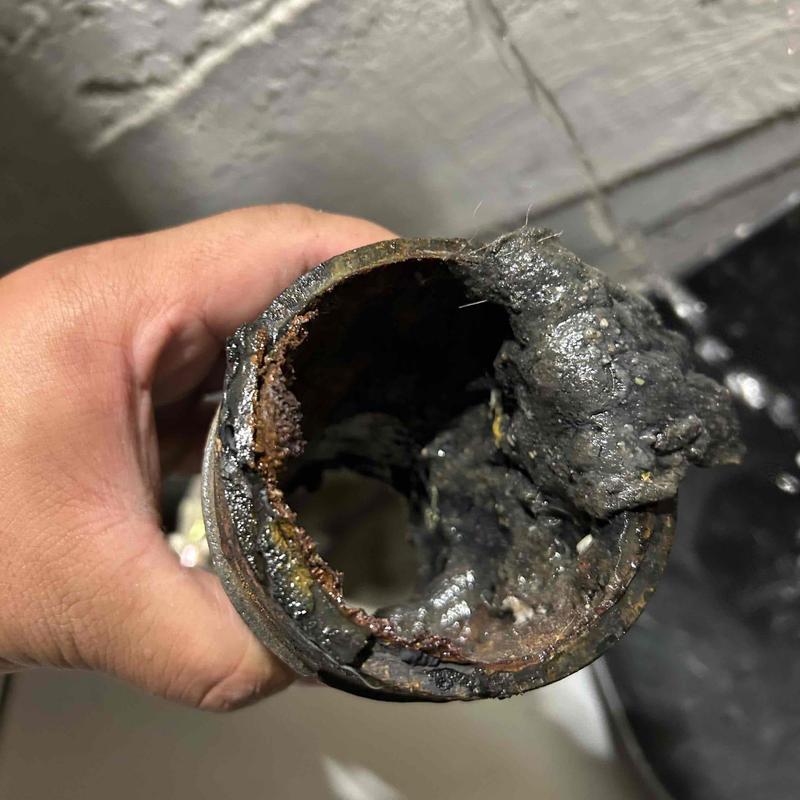 Cast iron pipe clogged with heavy rust and buildup
