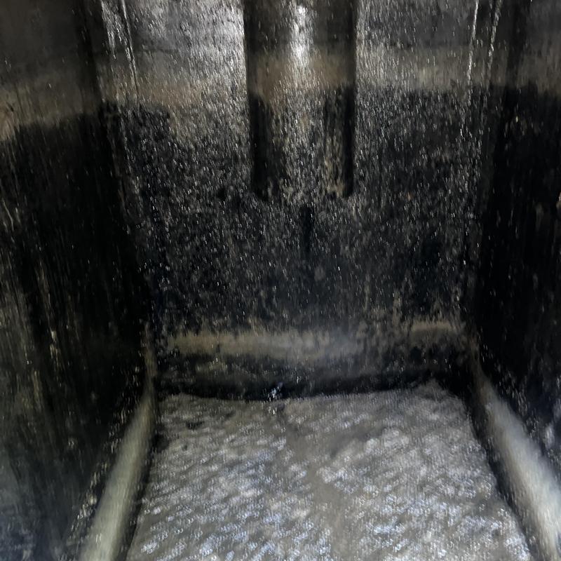Septic tank interior with thick crust buildup