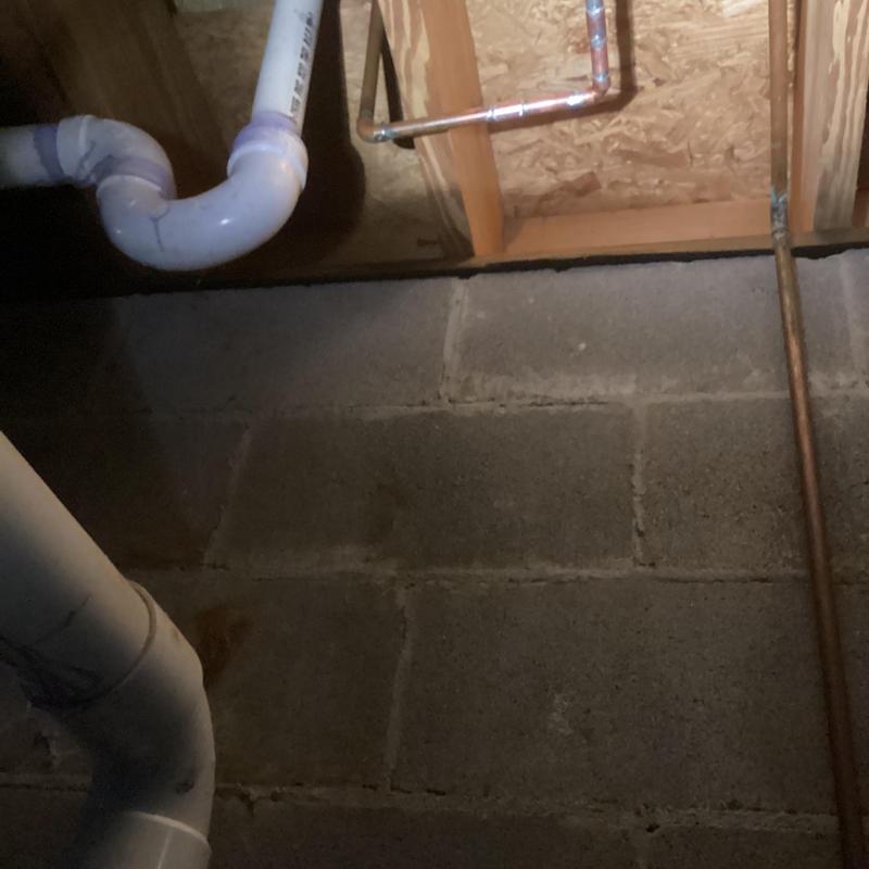 Copper water pipe and PVC drain in basement ceiling