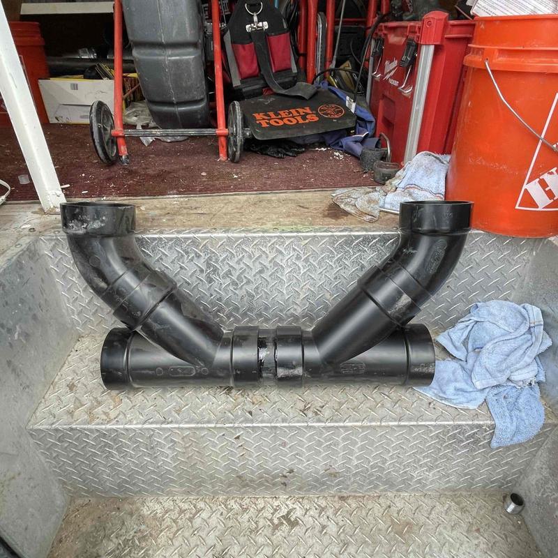 PVC sewer pipe Y-branch fitting on metal step