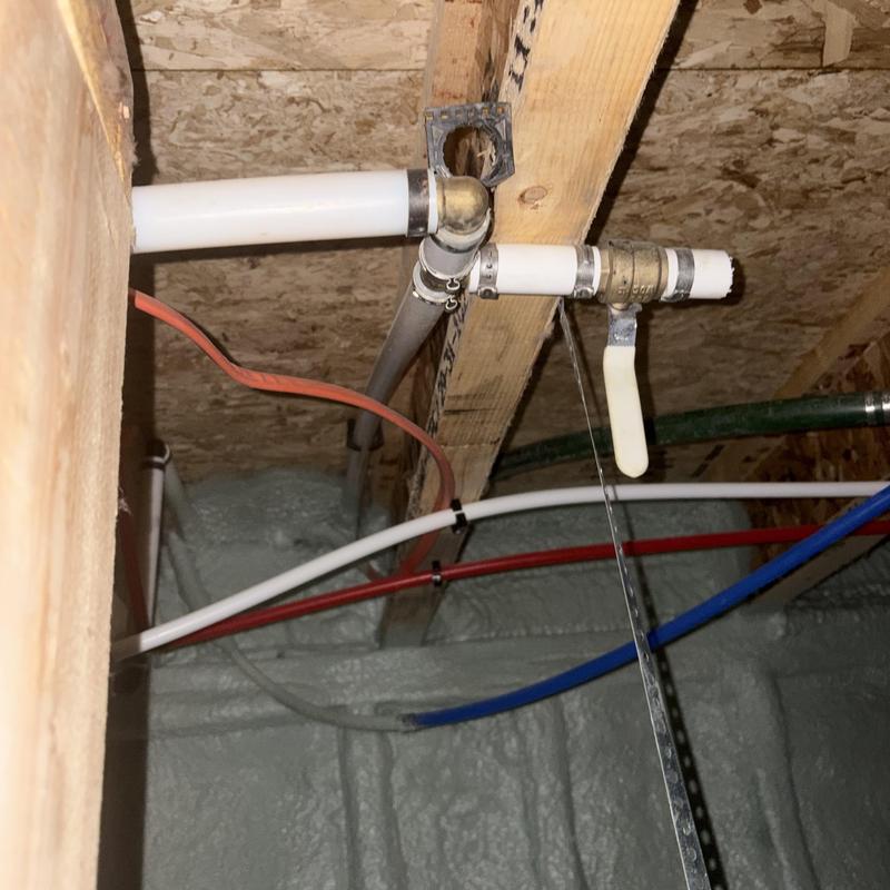 Ball valve with exposed cut pipe in crawl space plumbing