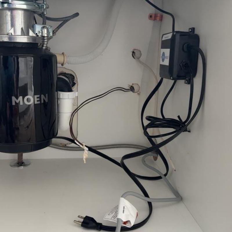 Garbage disposal installation with power supply box under sink
