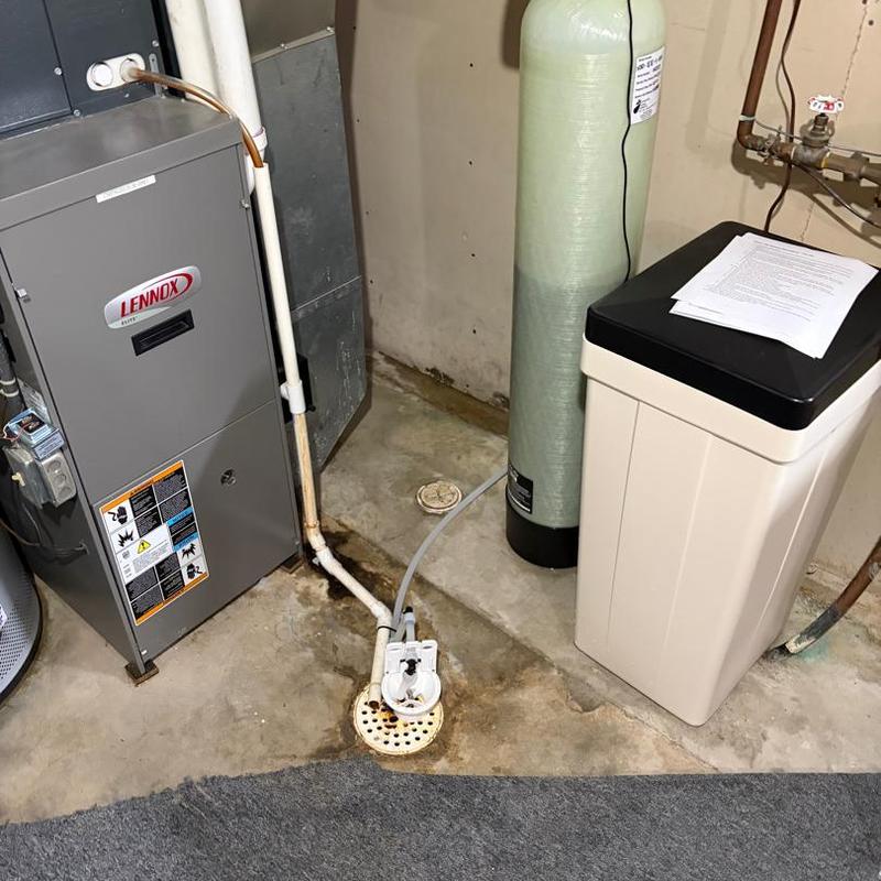 Water softener system next to furnace in basement