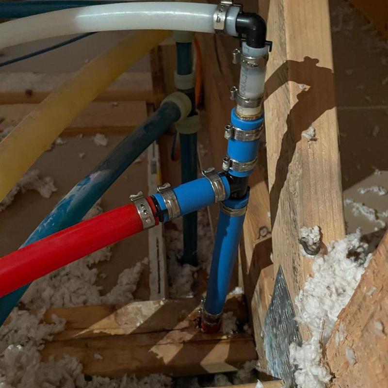 Pex B compression fittings above water heater with clamps