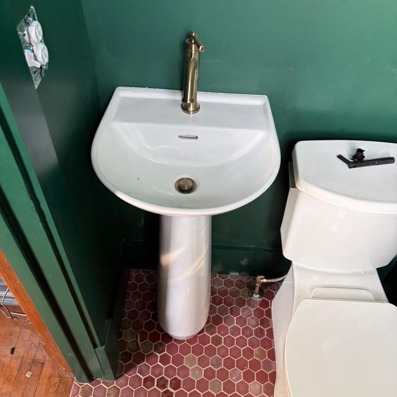Pedestal sink and faucet installation in basement bathroom