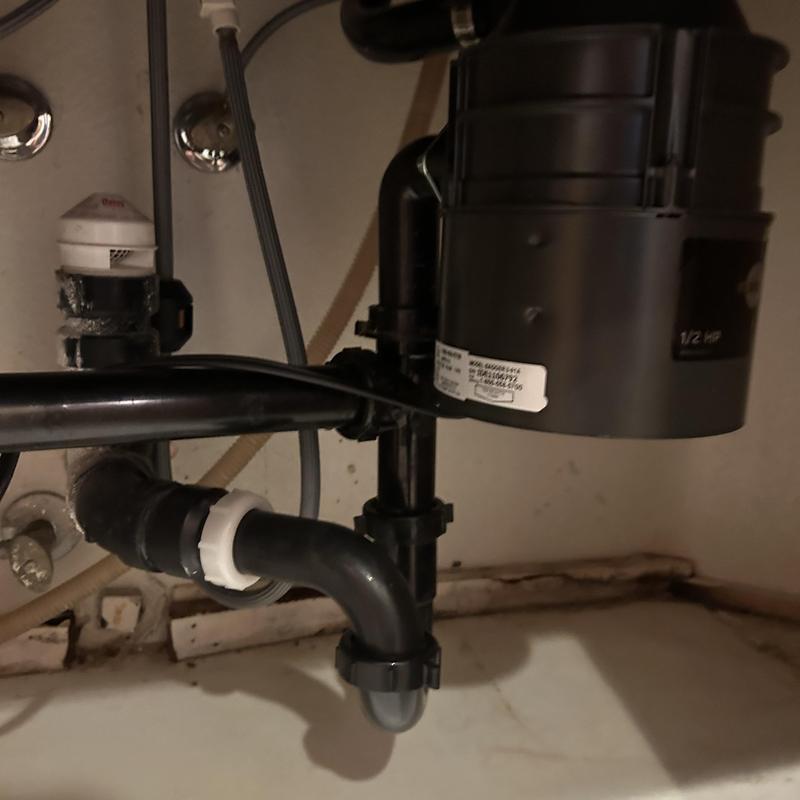 Garbage disposal unit and drain piping under sink