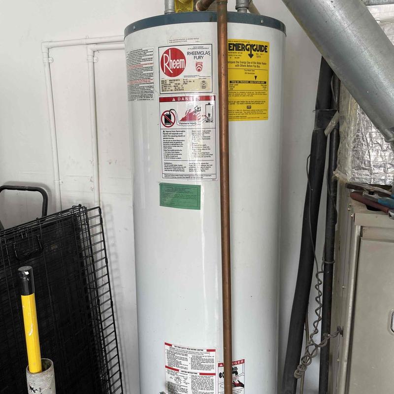 Water heater with copper pipe connections in utility room
