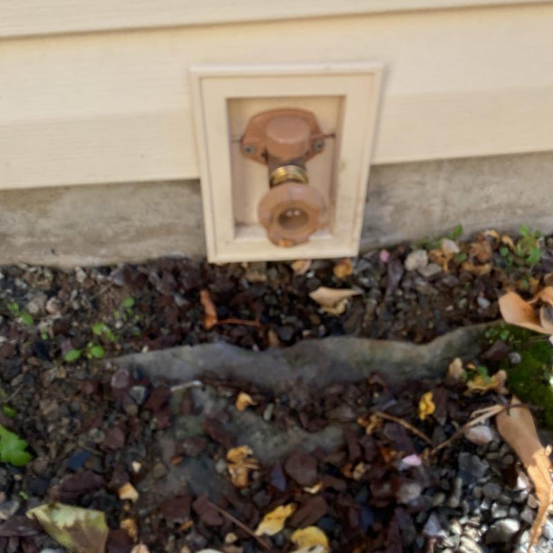 Outside faucet with new beacon replacement near foundation