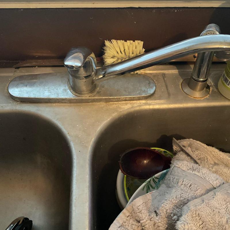 Kitchen faucet and sink with cleaning brush and towel