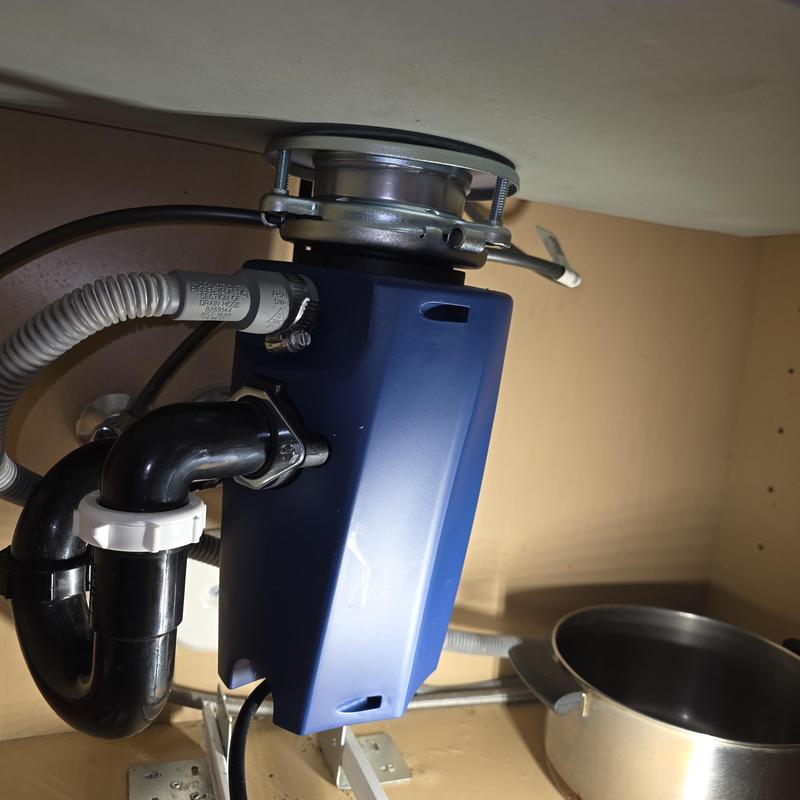 Garbage disposal unit with new flange installation under sink