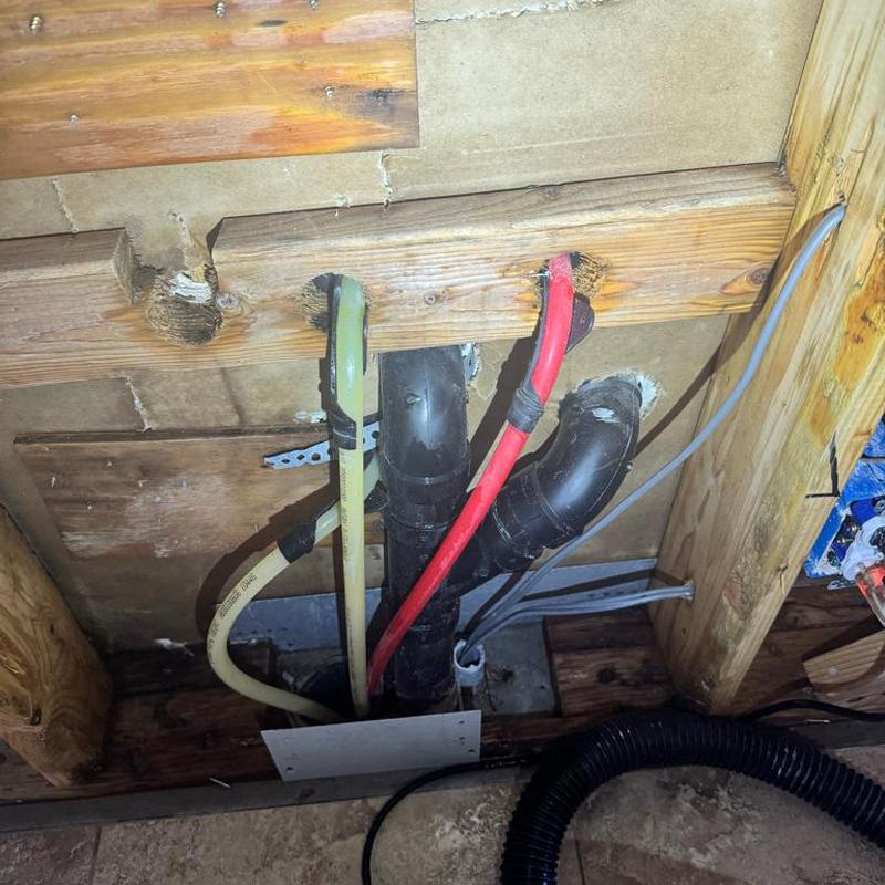 PEX plumbing and drain pipes under kitchen floor