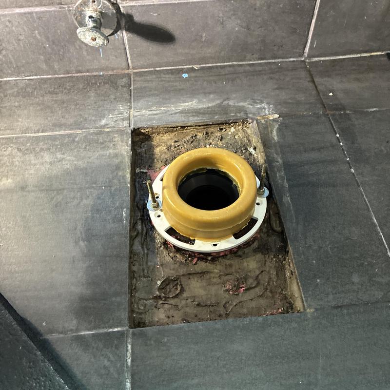 Toilet flange and wax ring installation on tile floor