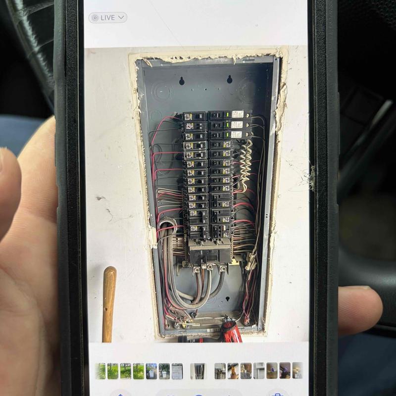 Electrical breaker panel with wiring inside wall cavity