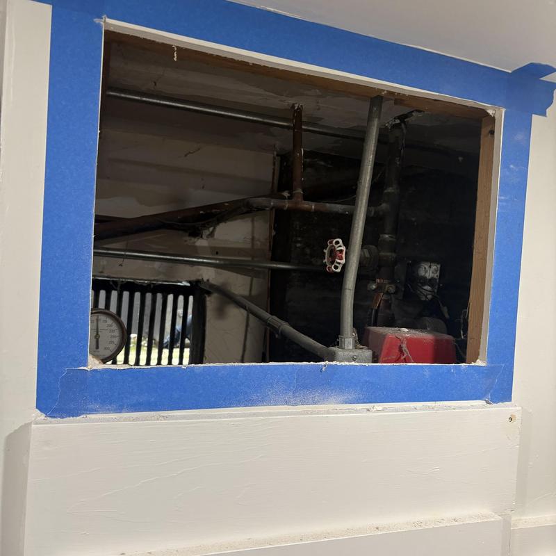 Water heater piping and valve installation in wall cavity