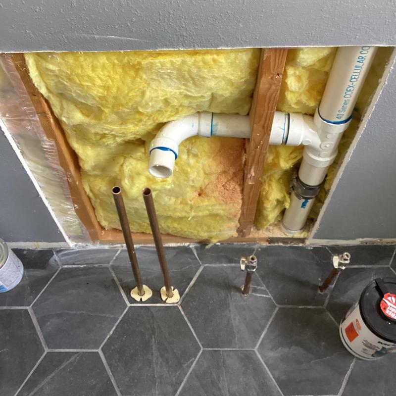 Shower plumbing rough-in with PVC drain and copper supply lines