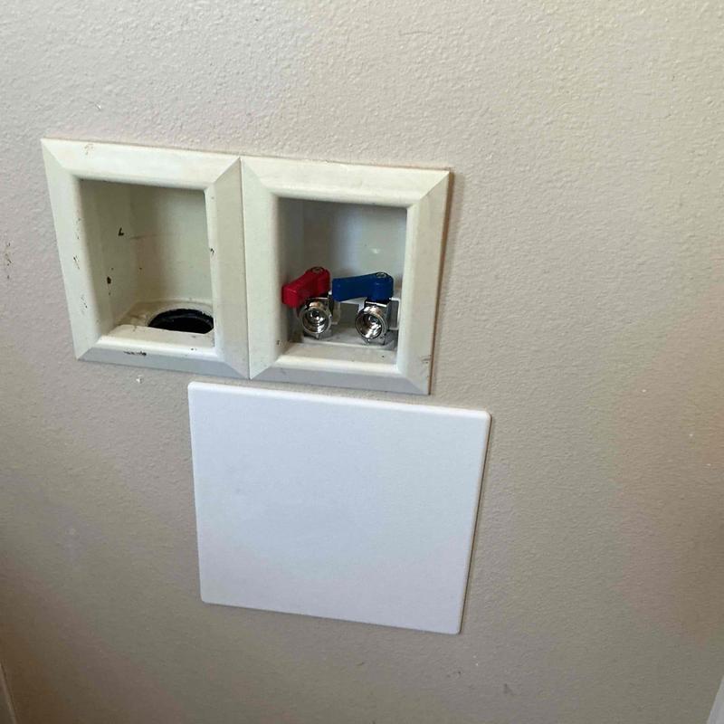 Laundry valves with red and blue handles installed